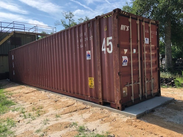 45 ft Red shipping container placed outdoors on a sunny day.