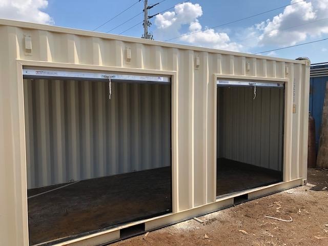 Two open steel storage containers under a sunny sky.