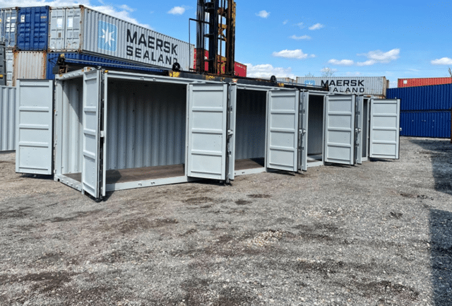 image n open-side multi door shipping container sitting in a depot, featuring bi-fold doors that open the entire length of the side wall for maximum loading clearance.
